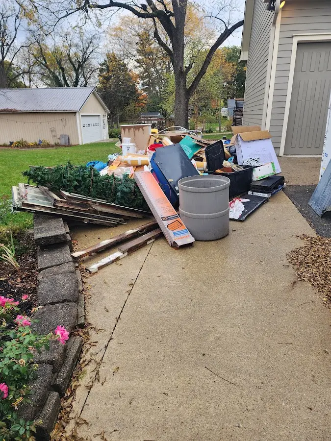 Dumpster being loaded with debris for Estate Cleanout Dumpster Rental in Ponder